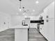 Modern kitchen featuring white cabinets, a large island, and sleek black faucet at 1873 E Ellis Dr, Tempe, AZ 85282