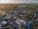 Aerial view of a house and neighborhood, showcasing the surrounding area and distant city skyline at 1873 E Ellis Dr, Tempe, AZ 85282