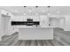 Bright white kitchen with an island, pendant lighting, and dark tile backsplash at 1873 E Ellis Dr, Tempe, AZ 85282