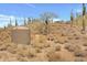 A large water tank sits on a desert lot with cacti at 43320 N 11Th St, New River, AZ 85087