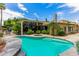 Inviting swimming pool with a spa and spacious patio area at 94 Biltmore Est, Phoenix, AZ 85016
