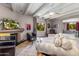 Living room with fireplace, comfy seating, and access to patio at 94 Biltmore Est, Phoenix, AZ 85016