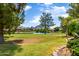 Scenic view of a lake, lush landscaping, and distant mountains at 94 Biltmore Est, Phoenix, AZ 85016