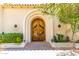 Impressive double wood doors and landscaping at 94 Biltmore Est, Phoenix, AZ 85016