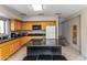 Kitchen with light wood cabinets, granite countertops, and island at 94 Biltmore Est, Phoenix, AZ 85016