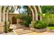 Elegant entry with arched walkway and ornate wooden doors at 94 Biltmore Est, Phoenix, AZ 85016