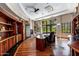 Home office with built-in desk and large window with scenic view at 94 Biltmore Est, Phoenix, AZ 85016