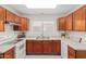 Modern kitchen with wood cabinets and stainless steel appliances at 4760 W Wahalla Ln, Glendale, AZ 85308