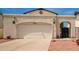 Front view of the house with a garage and landscaping at 4760 W Wahalla Ln, Glendale, AZ 85308