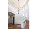 Elegant curved staircase with a stunning chandelier at 6737 E Rockaway Hills Dr, Cave Creek, AZ 85331