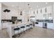 Modern kitchen with white cabinets, large island with seating, and wine cooler at 16032 E Dale Ln, Scottsdale, AZ 85262