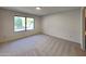 Bright bedroom with neutral carpeting and large window at 9623 W Wescott Dr, Peoria, AZ 85382
