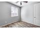 Bedroom with wood-look flooring and ceiling fan at 5557 W Buckskin Trl, Phoenix, AZ 85083