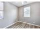 Cozy bedroom with wood-look flooring and neutral walls at 5557 W Buckskin Trl, Phoenix, AZ 85083