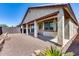 Covered patio, gravel backyard, and a low retaining wall at 5557 W Buckskin Trl, Phoenix, AZ 85083