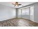 Spacious bedroom with wood-look floors and bay window at 5557 W Buckskin Trl, Phoenix, AZ 85083