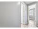 Hallway with tile floors, neutral paint, and access to bedrooms at 5557 W Buckskin Trl, Phoenix, AZ 85083