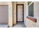 Front entry with decorative security door and neutral color scheme at 5557 W Buckskin Trl, Phoenix, AZ 85083