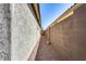 Landscaped side yard with gravel pathway and wood accents at 5557 W Buckskin Trl, Phoenix, AZ 85083