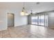 Bright dining room with tile floors and sliding glass doors leading to the backyard at 5557 W Buckskin Trl, Phoenix, AZ 85083