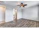 Light and airy bedroom with wood-look floors and access to bathroom at 5557 W Buckskin Trl, Phoenix, AZ 85083