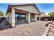 Backyard with gravel, covered patio, and a small landscaped area at 5557 W Buckskin Trl, Phoenix, AZ 85083