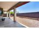 Covered patio overlooking a gravel backyard with a block wall at 5557 W Buckskin Trl, Phoenix, AZ 85083