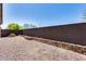 Backyard with gravel and a block wall providing privacy at 5557 W Buckskin Trl, Phoenix, AZ 85083