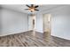 Well-lit bedroom with wood-look floors and access to kitchen and closet at 5557 W Buckskin Trl, Phoenix, AZ 85083