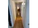 Long hallway with light walls and wood-look laminate flooring at 9501 E Broadway Rd # 221, Mesa, AZ 85208