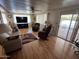 Bright living room featuring hardwood floors, comfy seating, and access to a deck at 9501 E Broadway Rd # 221, Mesa, AZ 85208