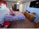 Main bedroom with king-size bed, dresser, and laminate flooring at 9501 E Broadway Rd # 221, Mesa, AZ 85208