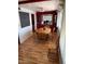A dining area with a wooden table and chairs, red built-ins, and laminate floors at 9501 E Broadway Rd # 221, Mesa, AZ 85208