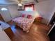 Spacious main bedroom with king-size bed and wood laminate floors at 9501 E Broadway Rd # 221, Mesa, AZ 85208