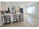 Modern kitchen with an island, white cabinets, and breakfast bar at 17511 N Kimberly Way, Surprise, AZ 85374
