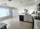 Open concept kitchen with island, white cabinets, and views to the dining area at 17511 N Kimberly Way, Surprise, AZ 85374