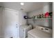 Laundry room with washer, dryer, and storage shelves at 17511 N Kimberly Way, Surprise, AZ 85374