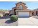 Two-story home with attached garage and well-maintained landscaping at 17511 N Kimberly Way, Surprise, AZ 85374