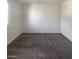 Well-lit bedroom featuring grey carpet and a closet at 14631 N 36Th Pl, Phoenix, AZ 85032