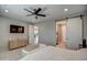 Spacious bedroom with a large TV, dresser, and ensuite access at 1859 N Westfall Ln, Casa Grande, AZ 85122