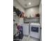 Bright laundry room with washer, dryer, and storage shelves at 1859 N Westfall Ln, Casa Grande, AZ 85122