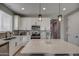 Modern kitchen with white cabinets, quartz countertops, and an island at 1859 N Westfall Ln, Casa Grande, AZ 85122