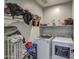 Bright laundry room with washer, dryer, and storage shelves at 1859 N Westfall Ln, Casa Grande, AZ 85122