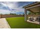 Backyard with artificial turf and covered patio at 1859 N Westfall Ln, Casa Grande, AZ 85122