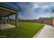 Backyard with artificial turf and covered patio at 1859 N Westfall Ln, Casa Grande, AZ 85122