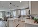 Modern kitchen with white cabinets, island, and stainless steel appliances at 1859 N Westfall Ln, Casa Grande, AZ 85122