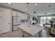 Open concept kitchen with white cabinets and a large island at 1859 N Westfall Ln, Casa Grande, AZ 85122