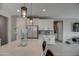 Modern kitchen with white cabinets and stainless steel appliances at 1859 N Westfall Ln, Casa Grande, AZ 85122