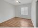 Simple bedroom with wood-look floors and a window at 11168 E Lost Canyon Ct, Gold Canyon, AZ 85118