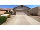 Front view of a single-story home with a two-car garage and stone accents at 11168 E Lost Canyon Ct, Gold Canyon, AZ 85118
